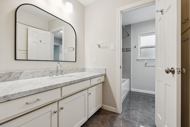 full bathroom featuring tub / shower combination, baseboards, and vanity