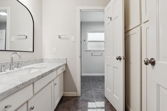 bathroom featuring vanity and baseboards