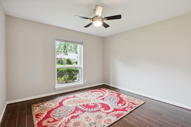 unfurnished room featuring baseboards, wood finish floors, and a ceiling fan