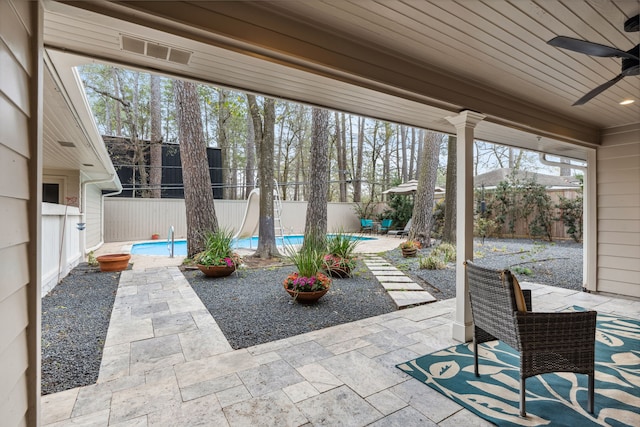 view of patio / terrace with a ceiling fan, a fenced in pool, and a fenced backyard