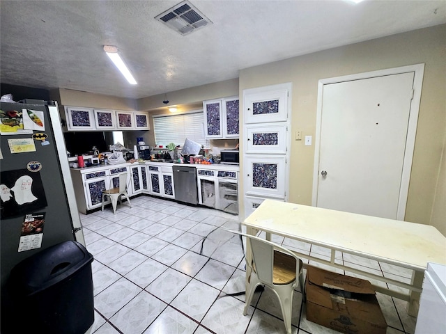 kitchen featuring light countertops, light tile patterned floors, visible vents, and appliances with stainless steel finishes