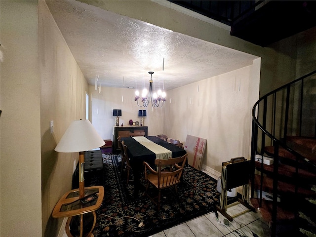 dining area with stairs, an inviting chandelier, and a textured ceiling