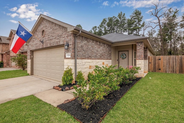 view of front facade with a front lawn, driveway, fence, a garage, and brick siding