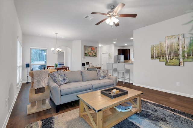 living area featuring visible vents, baseboards, ceiling fan with notable chandelier, recessed lighting, and dark wood-style floors