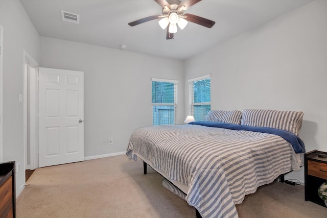 bedroom with visible vents, a ceiling fan, baseboards, and carpet floors