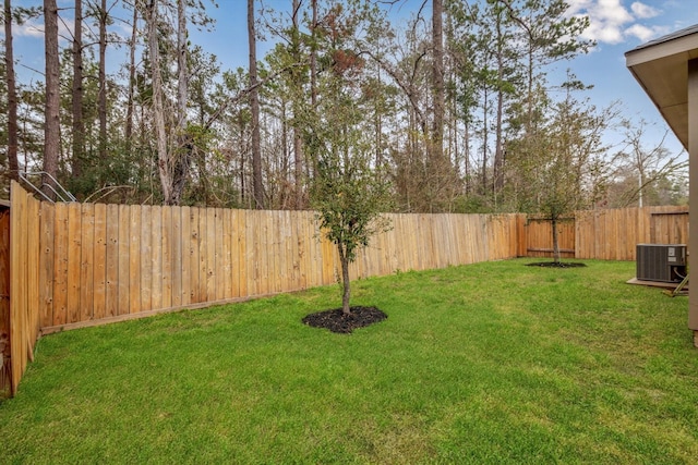 view of yard with cooling unit and a fenced backyard