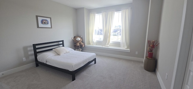 bedroom featuring baseboards and carpet flooring