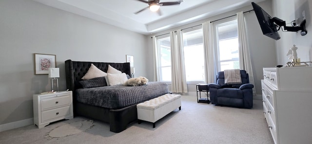 bedroom with light colored carpet, a ceiling fan, and baseboards