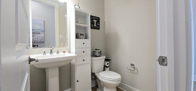 half bath with a sink and toilet