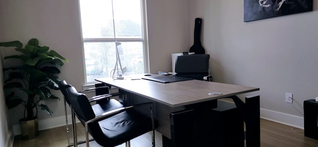 home office with a wealth of natural light, baseboards, and wood finished floors