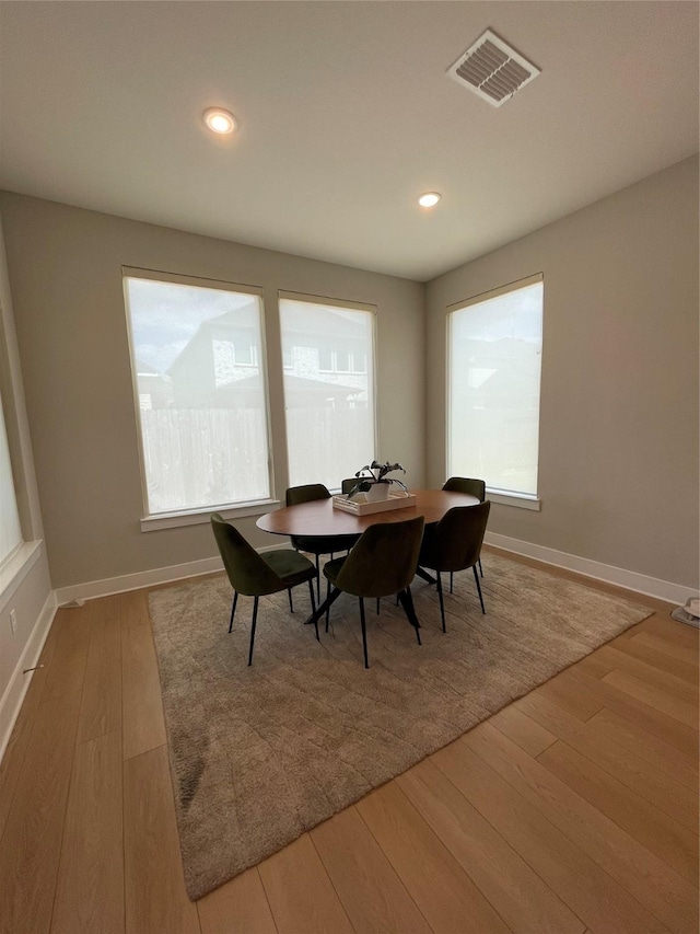 dining room with visible vents, recessed lighting, baseboards, and wood finished floors