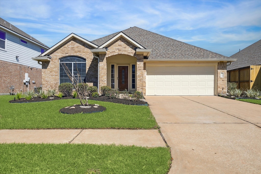 view of front of property featuring a garage, brick siding, concrete driveway, and a shingled roof