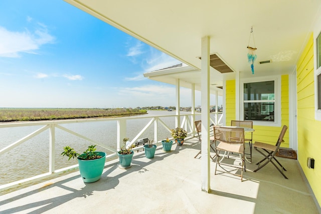 view of patio with visible vents, outdoor dining area, and a water view