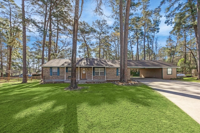 ranch-style house featuring a front lawn, an attached carport, fence, concrete driveway, and brick siding