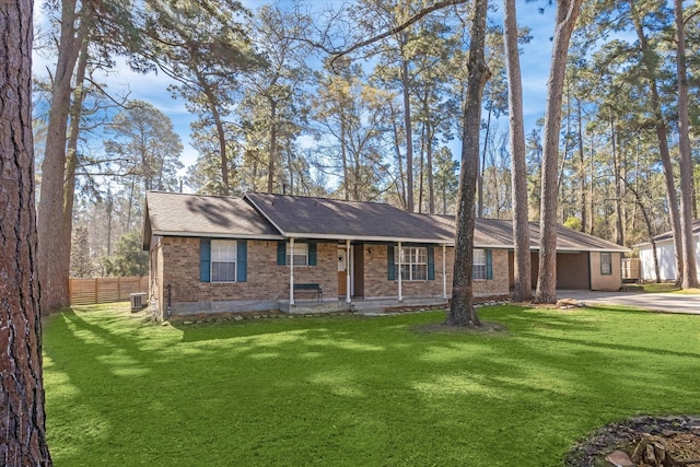 ranch-style house featuring fence, driveway, central AC, a front lawn, and brick siding