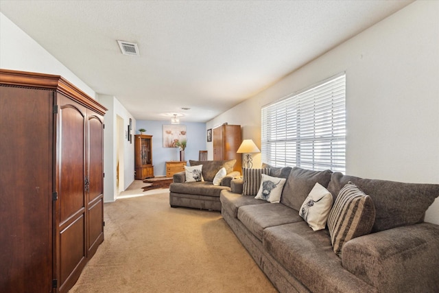 living room featuring light carpet and visible vents