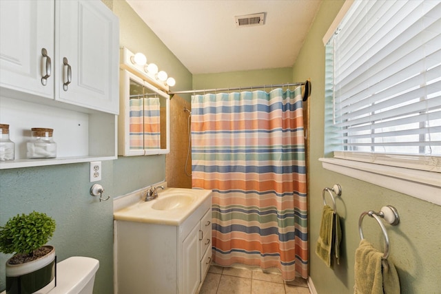 bathroom featuring tile patterned flooring, visible vents, toilet, a shower with curtain, and vanity