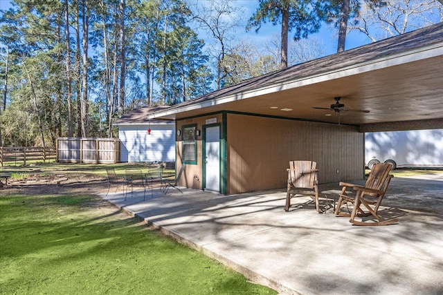 view of patio with ceiling fan and fence