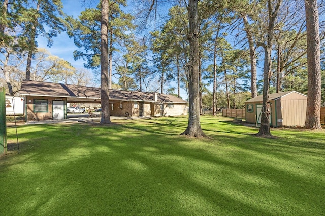 view of yard with an outdoor structure and fence