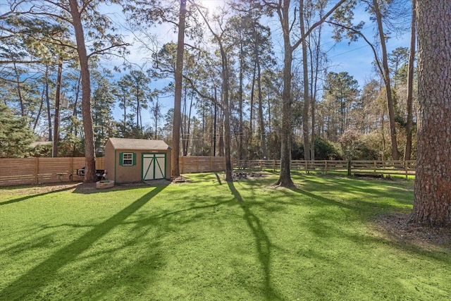 view of yard with a fenced backyard, an outbuilding, and a storage shed