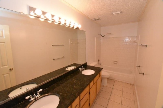 full bath featuring a textured ceiling, tile patterned floors, and a sink