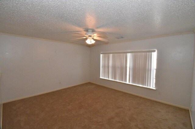 carpeted empty room with baseboards, a textured ceiling, and a ceiling fan