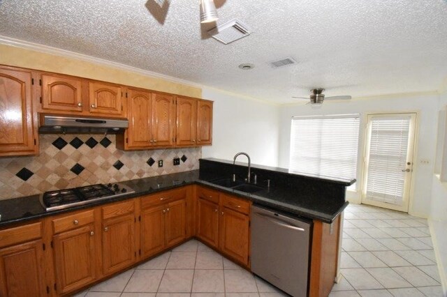 kitchen with a peninsula, ceiling fan, stainless steel appliances, under cabinet range hood, and brown cabinets