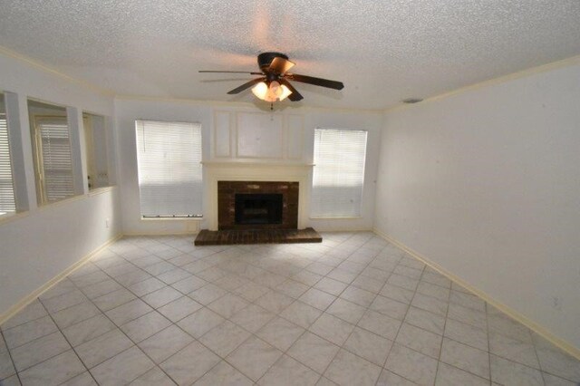 unfurnished living room with a brick fireplace, light tile patterned flooring, a ceiling fan, and baseboards