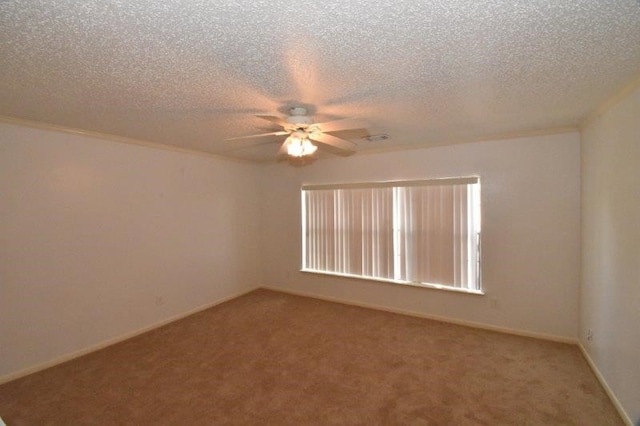 spare room featuring baseboards, light colored carpet, a ceiling fan, and a textured ceiling