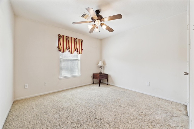 carpeted empty room featuring visible vents, baseboards, and a ceiling fan