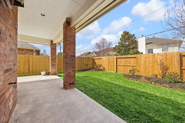 view of yard featuring a patio area and a fenced backyard