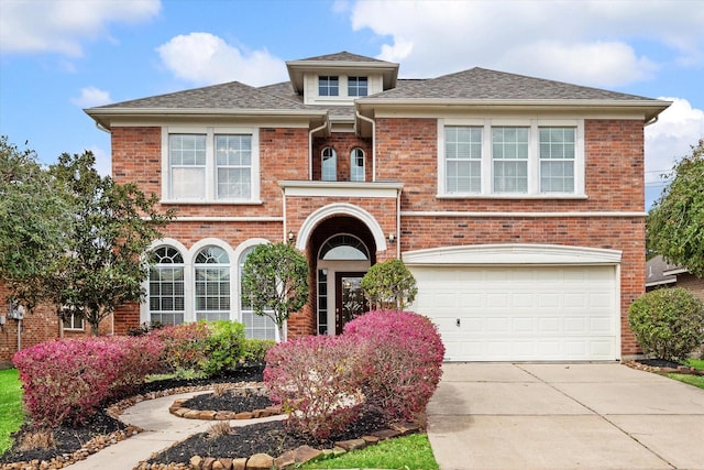 view of front of property featuring concrete driveway, a garage, and brick siding