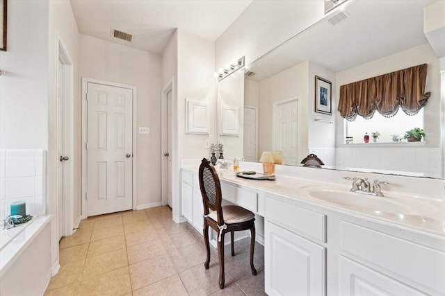 full bathroom with tile patterned flooring, visible vents, vanity, and a tub to relax in