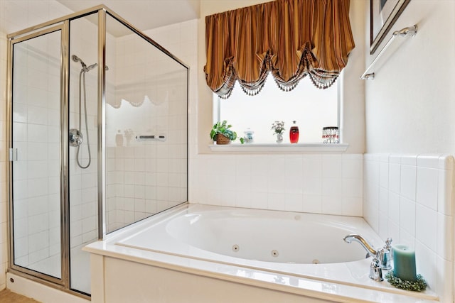 full bathroom featuring a jetted tub and a stall shower