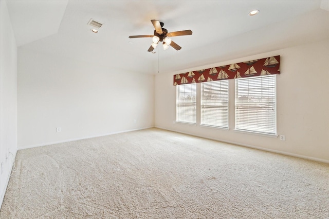 carpeted empty room featuring visible vents, baseboards, vaulted ceiling, recessed lighting, and a ceiling fan