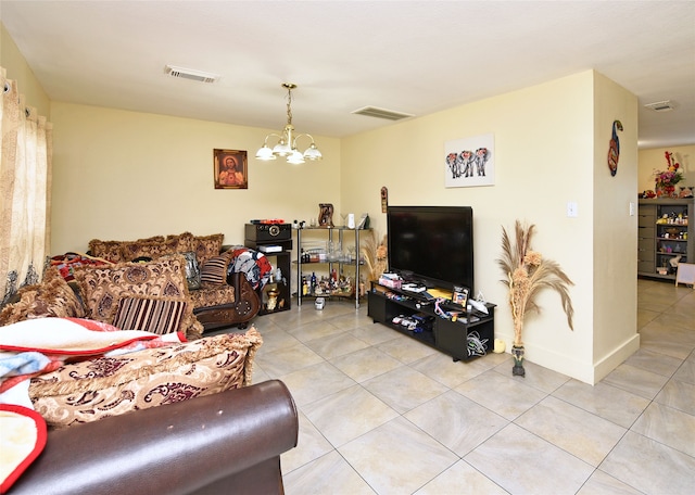 living area featuring a notable chandelier, visible vents, and tile patterned flooring