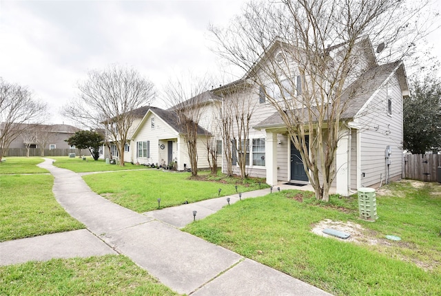 view of front facade with a front lawn and fence