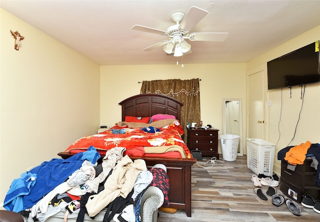 bedroom with a ceiling fan and wood finished floors