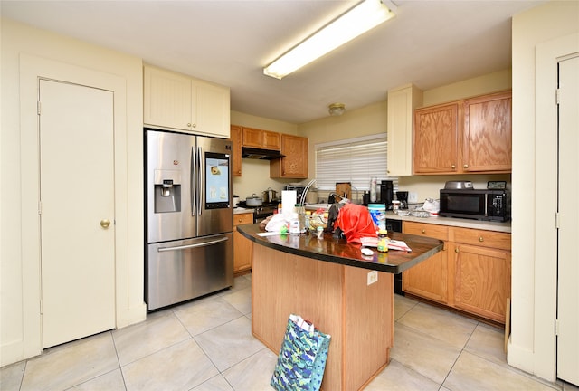 kitchen featuring under cabinet range hood, stainless steel fridge, black microwave, and light tile patterned floors