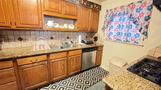 kitchen featuring black gas stovetop, a sink, tasteful backsplash, light stone countertops, and dishwasher