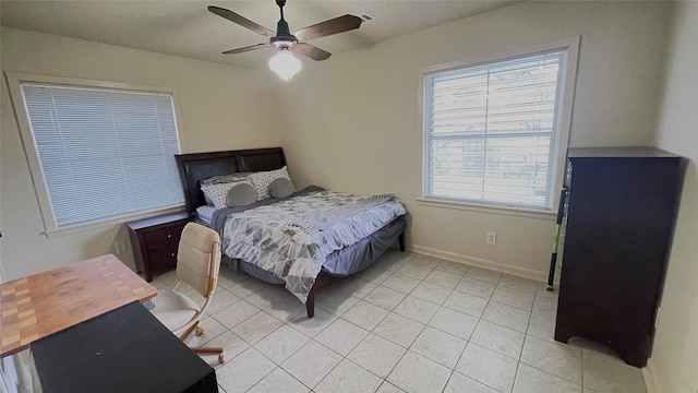 bedroom featuring light tile patterned floors, baseboards, and ceiling fan