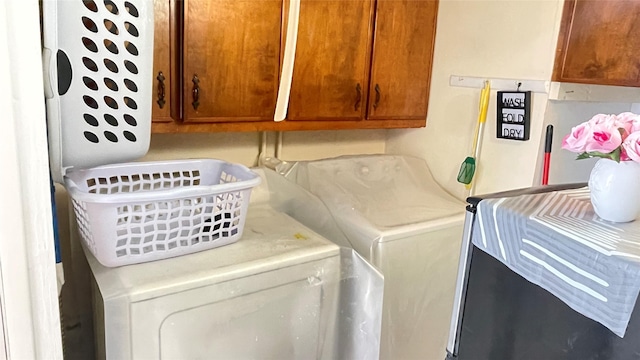 laundry area featuring cabinet space and separate washer and dryer