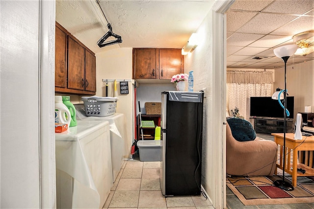 clothes washing area featuring cabinet space, visible vents, washing machine and dryer, and light tile patterned floors