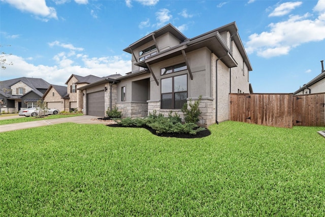 view of front of property with stucco siding, a garage, concrete driveway, and a front lawn