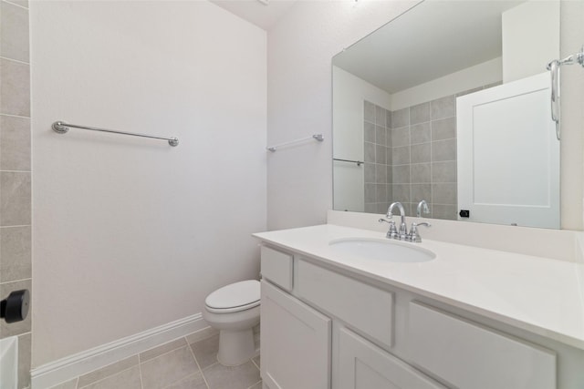 bathroom with tile patterned flooring, toilet, vanity, and baseboards