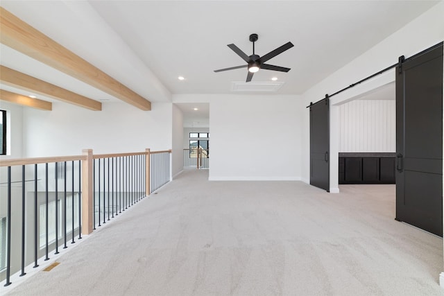 unfurnished room featuring carpet, baseboards, beam ceiling, recessed lighting, and a barn door