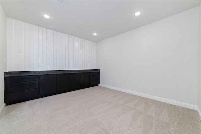 carpeted empty room with recessed lighting, visible vents, and baseboards