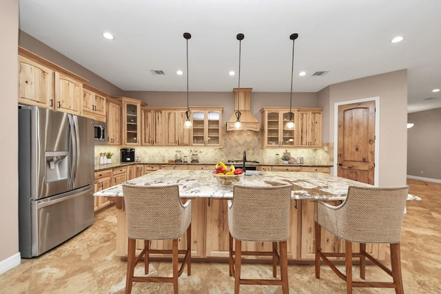 kitchen featuring custom exhaust hood, a center island with sink, visible vents, and stainless steel appliances