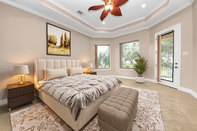 bedroom featuring visible vents, baseboards, a tray ceiling, and ornamental molding