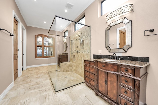 bathroom featuring a shower stall, plenty of natural light, crown molding, and visible vents